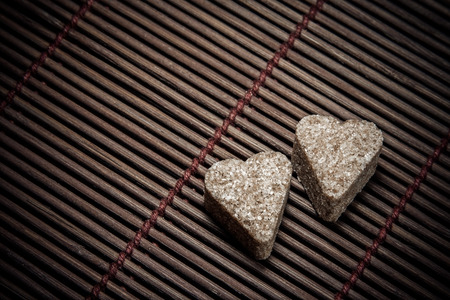 Two sugar hearts on wooden textureの写真素材
