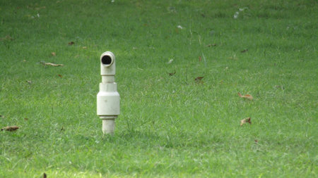 water sprinkler on green grass in the park. High quality photo