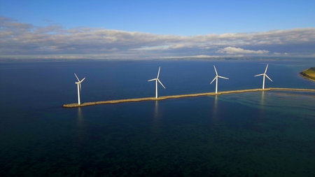 Aerial view of wind turbines in the sea. Renewable energy.