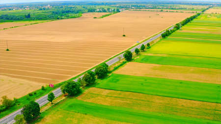 Aerial view of the highway through the fields. Rural landscape.の写真素材