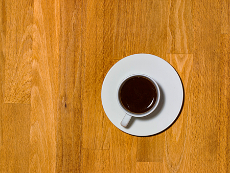 Expressed. Tasty traditional Italian coffee served in a decentralized small white cup on a wooden backgroundの写真素材