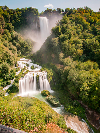 aerial view of the Marmore Falls, a waterfall nestled in a green forest on a beautiful summer day (Cascata delle Marmore, Umbria, Italy)の写真素材