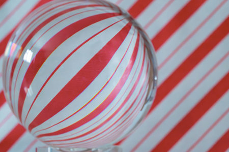 Close up of a crystal ball on a red and white striped backgroundの写真素材
