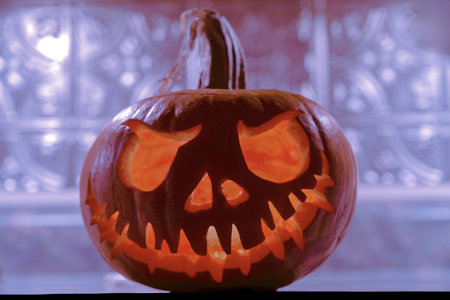 Halloween pumpkin head jack-o-lantern on bokeh backgroundの写真素材