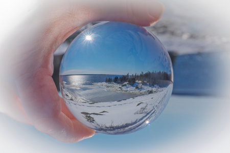 crystal ball with reflection of winter landscape North Shore, Quebecの写真素材