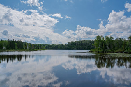 Landscape with a lake and clouds in the blue sky, Canadaの写真素材