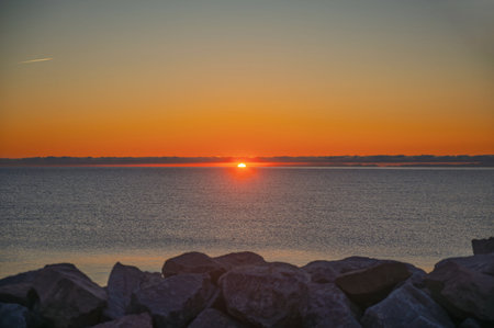 Sunset over the horizon in Baie-Comeau, Quebec, Canadaの写真素材