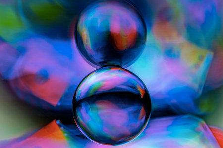 mirror reflecting a crystal ball illuminated by rainbow light paintingの写真素材