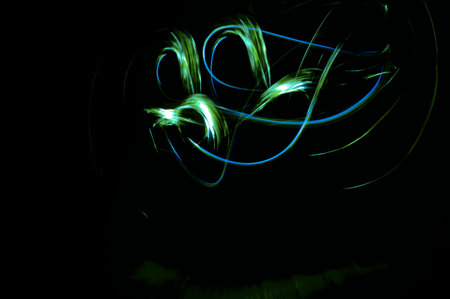 Colorful abstract light painting on black background, looking like a dragonの写真素材