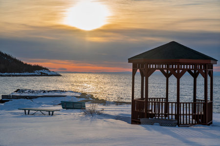 Wooden gazebo on the shore of the sea, at sunriseの写真素材