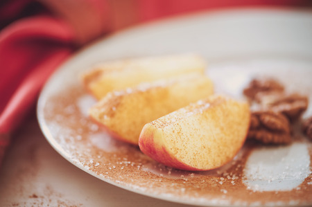 An apple is sliced into wedges and cored using a handy kitchen tool.の写真素材