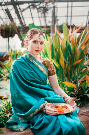 The european girl in the blue Indian costume.の写真素材