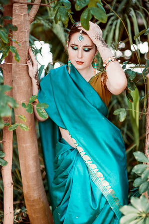 The european girl in the blue Indian costume.