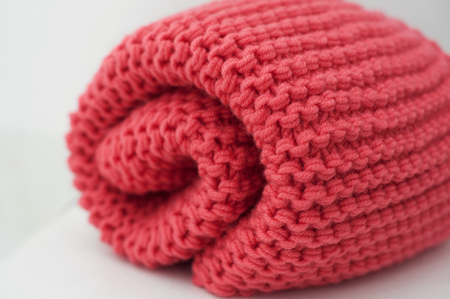 Close up red wool scarf roll package.の写真素材