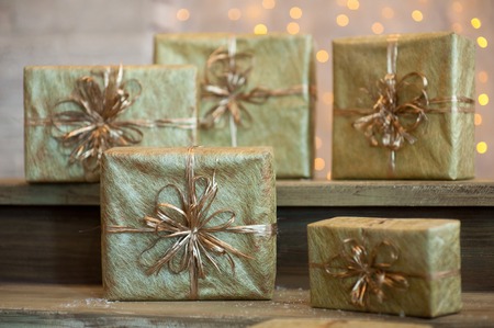 Golden gift boxes on abstract background,