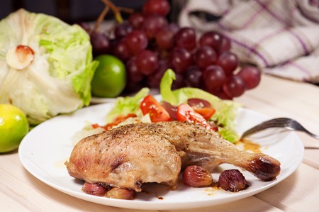 Baked chicken with red grapes.の写真素材
