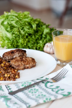 Buckwheat porridge with vegetables and meatballs.の写真素材