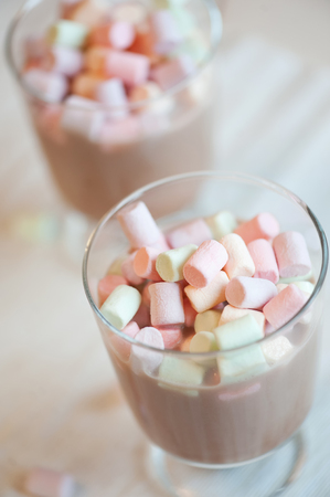 Cup of hot chocolate with marshmallows on white wooden backgroundの写真素材