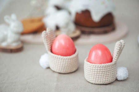 Pink Easter eggs in a basket with ears and a ponytail. Easter decor