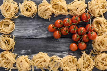 Pasta with tomatoes on wooden backgroundの写真素材