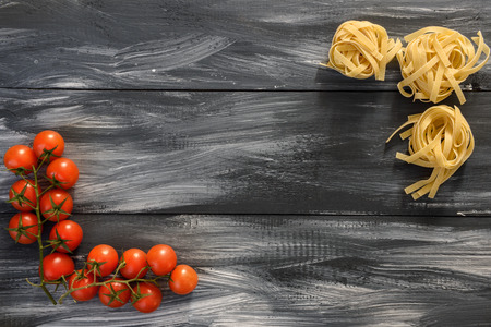 Pasta with tomatoes on wooden backgroundの写真素材