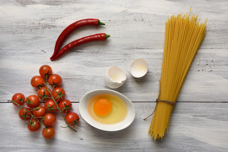 Pasta with tomatoes on wooden backgroundの写真素材