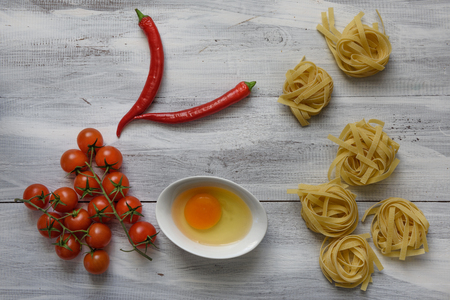 Pasta with tomatoes on wooden backgroundの写真素材