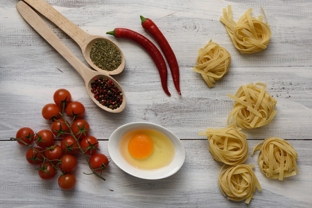 Pasta with tomatoes on wooden backgroundの写真素材