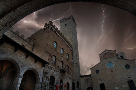 view during a thunderstorm with lightning of the town of san gimignano in tuscanyの写真素材