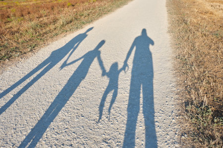 shadow of a family reflected on a pathの写真素材