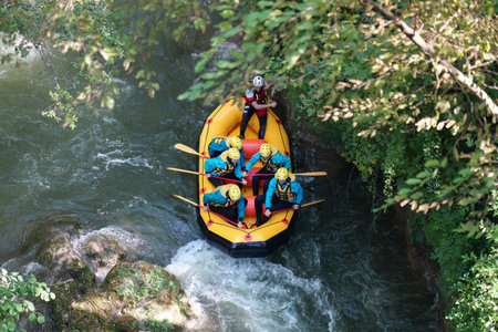 six people traveling the rapids of the Marmore waterfalls in Italy by dinghy