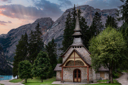 small church located on the shores of lake braies in trentino alto adigeの写真素材