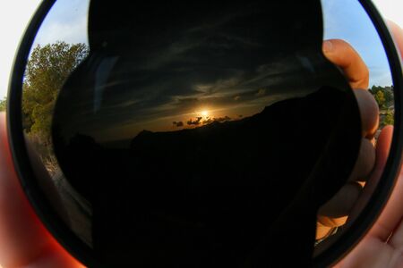Sunset landscape reflected in the wide angle lens