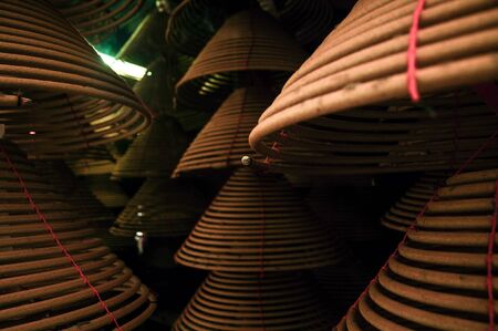 Temple interior Large spiral incense cones hanging from roofの写真素材