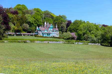 Chepstow, Wales / UK - May 06,2020: Welsh-style house in Woodcroft with green field in springtime.のeditorial素材