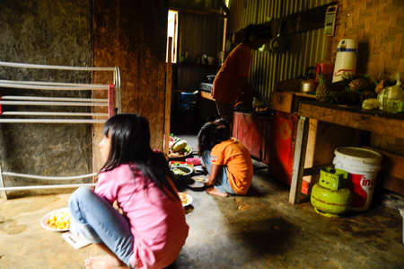 Mount Salak, Bogor, West Java / Indonesia - June 16, 2010: Indonesian Children sitting in the house looking out of the doorのeditorial素材