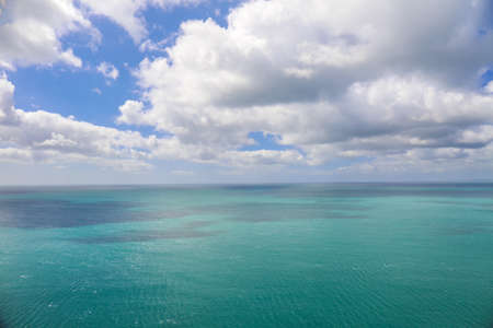 Ocean view with turquoise water and blue sky with cloudsの写真素材