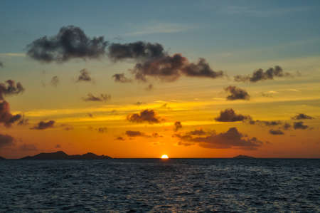 Wonderful Sunset over the sea with island in silhouetteの写真素材