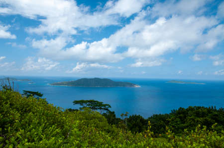Panorama over La Digue Island from the hill with the ocean and cloudy sky