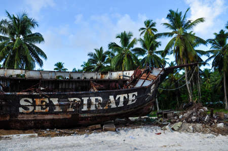 Rusty old pirate ship on the shore of the island. La Digue island, Seychellesのeditorial素材