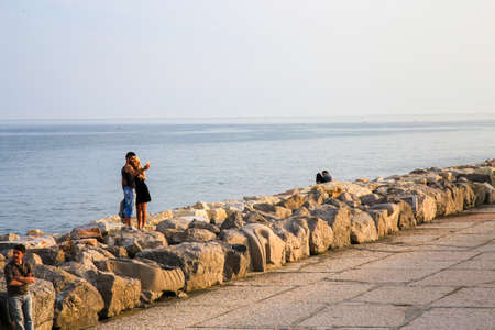 People stroll along the promenade of Caorle Italyのeditorial素材