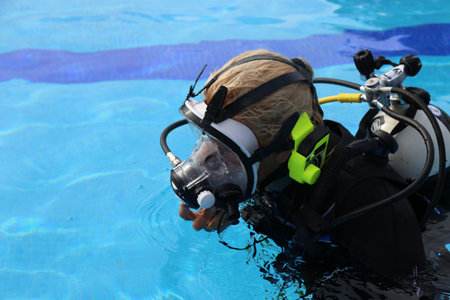 A woman wear a full face diving mask with ear comm ready for the training in the pool. Full Face...