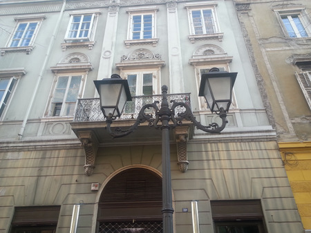 An example of historic lamppost in front of a neoclassic building in the centre of Triesteの写真素材