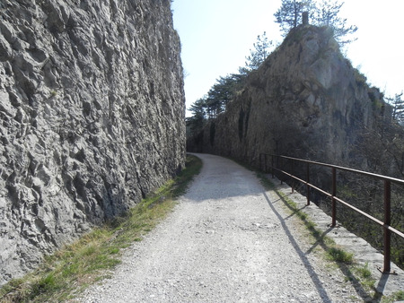 Between the rocks before the curve on the old railway trailの写真素材