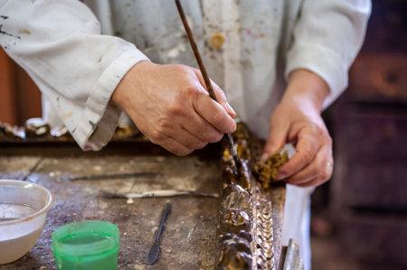 Close up of the hands of a craftsman working in his workshopの写真素材