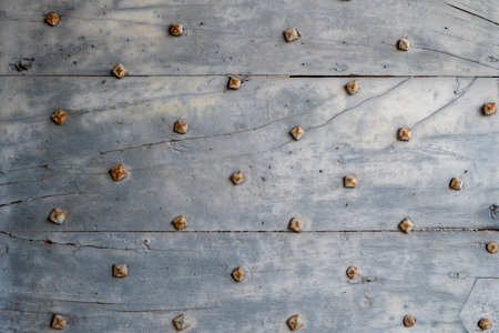 Old wooden door with rivets, close-up, background.の写真素材
