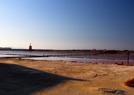 salt flats at sunset with promontory in the background