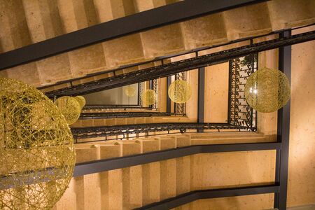 evocative image of textures of old 50s building stairs seen from belowの写真素材