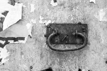 evocative black and white image of an old rusty door handleの写真素材