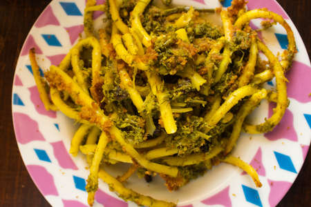 evocative image of a traditional Sicilian spaghetti dish called spaghetti con broccoli arriminati...